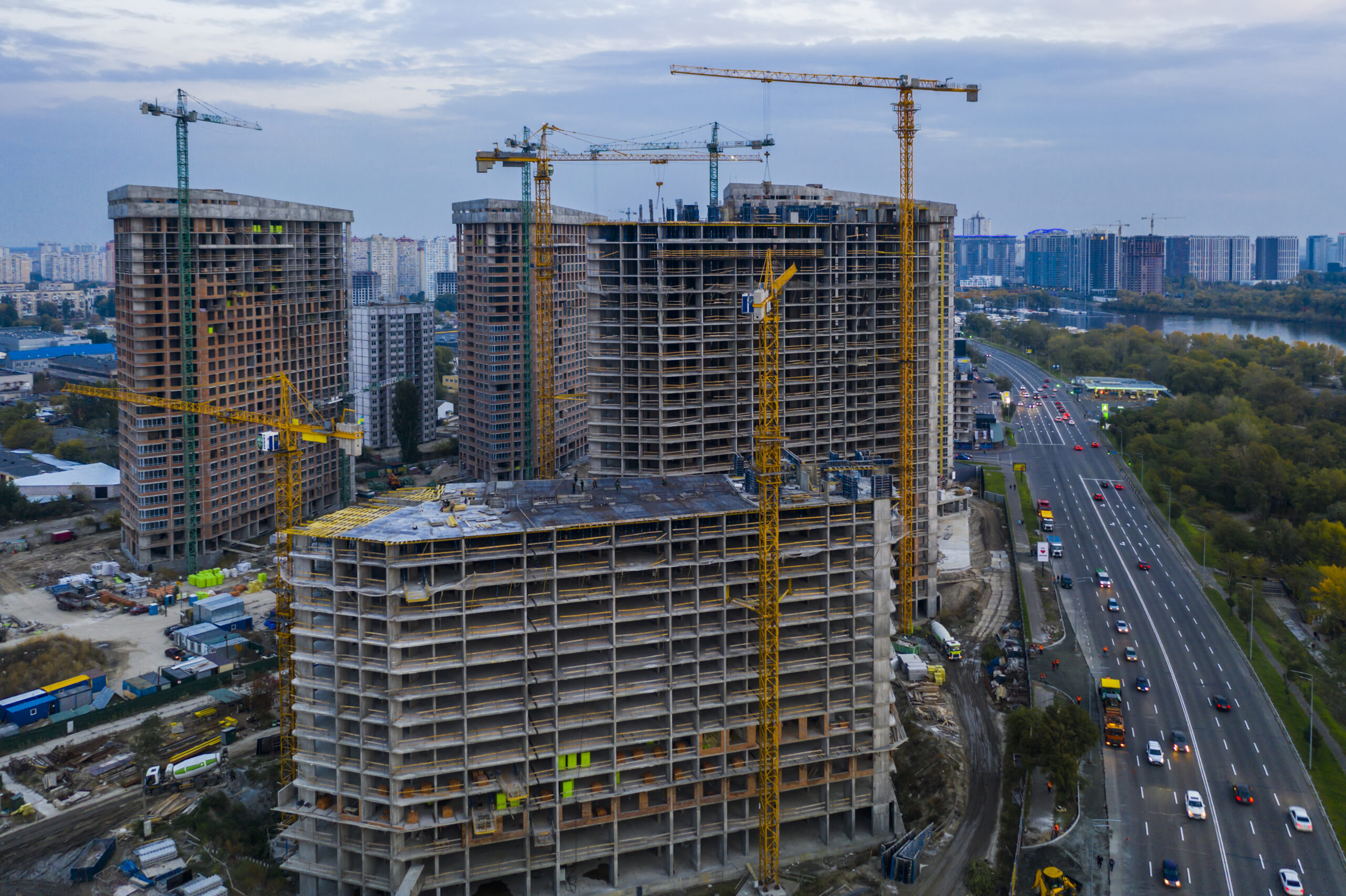 Construction site with cranes at sunset. Construction of an apartment building