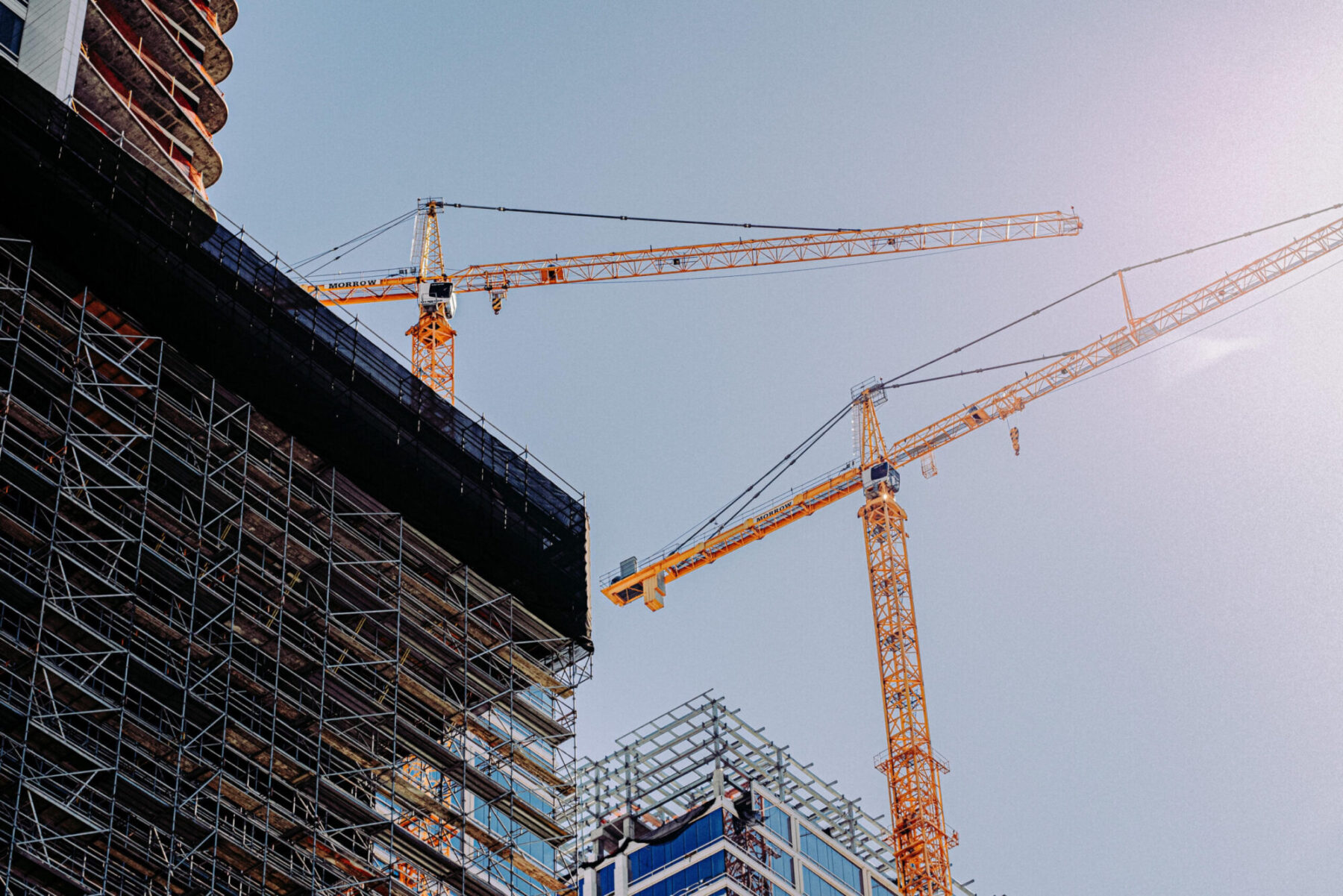 low-angle-of-two-cranes-in-a-construction-site-und-2026-01-07-07-37-14-utc
